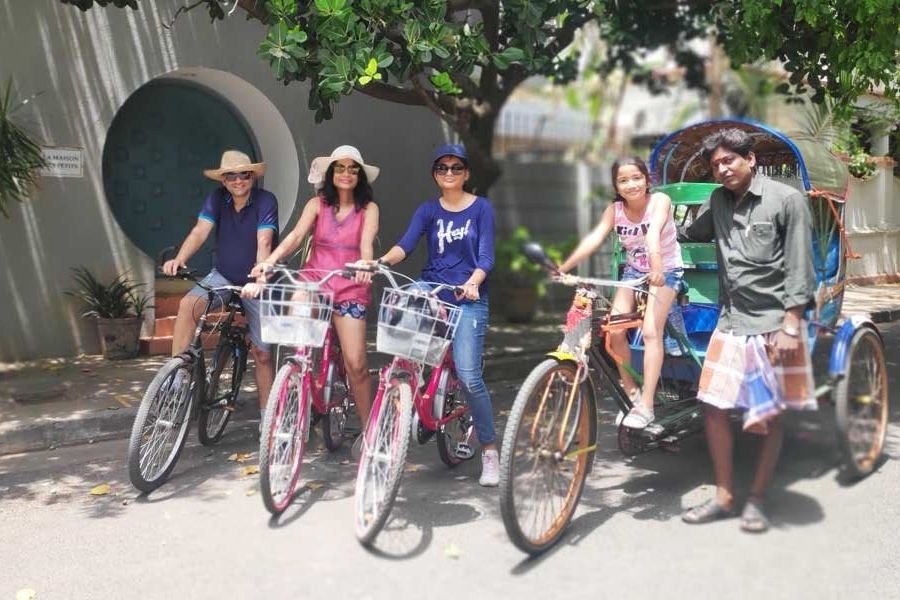Guests on a guided heritage cycle tour stopping on a street in Pondicherry