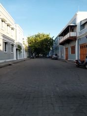 A quiet cobbled street in Pondicherry's French quarter lined with colonial houses and wooden balconies